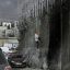 Palestinians in West Bank Risk Crossing Israel’s Separation Barrier to Flee Failing Economy