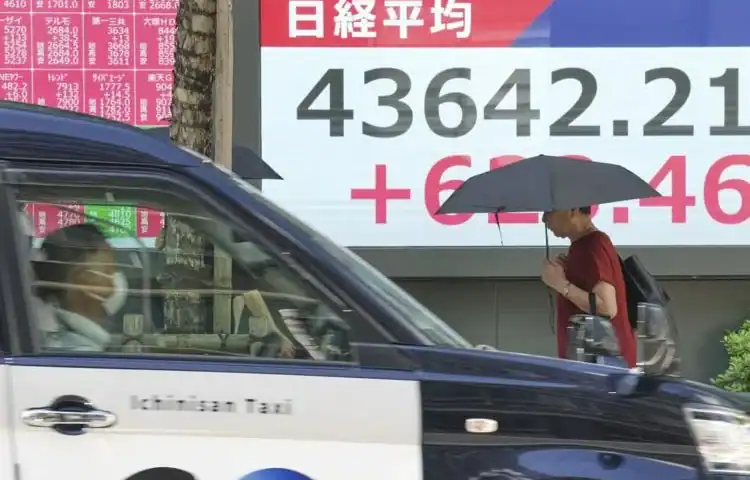 Asian shares are mixed as tech shares lead Wall Street to more records